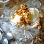 sheet pan with two spoons and a glass with two scoops of ice cream and caramel popcorn.