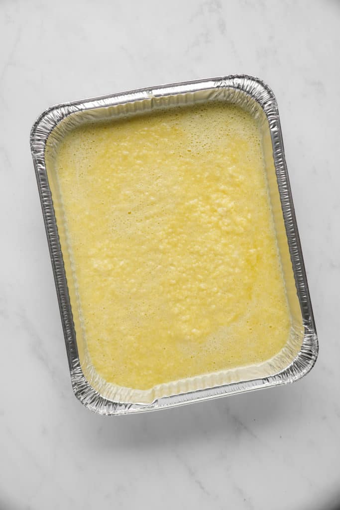 Pan with raw kugel for the best overnight potato kugel.