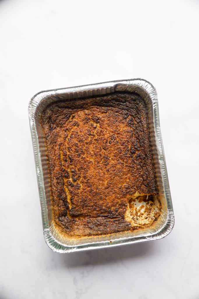 The best overnight potato kugel with a piece cut out.