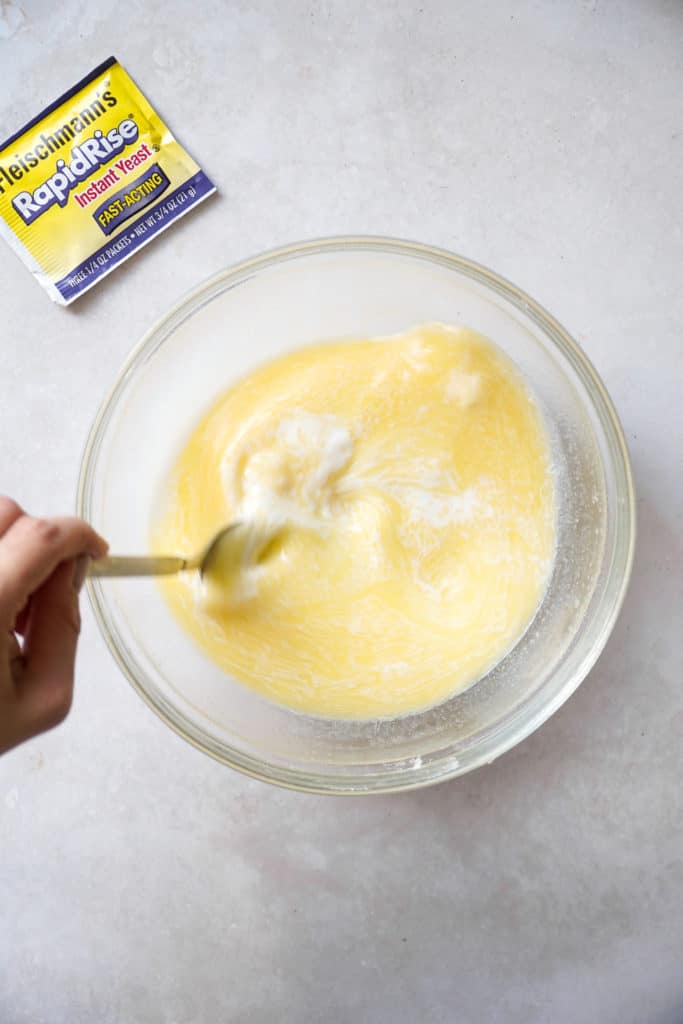 Whisking milk and butter for easy homemade cinnamon buns.