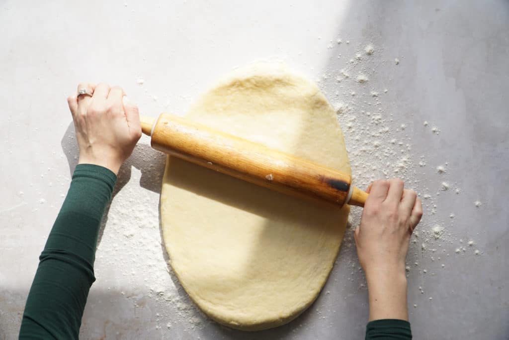 Rolling out dough for easy homemade cinnamon buns.