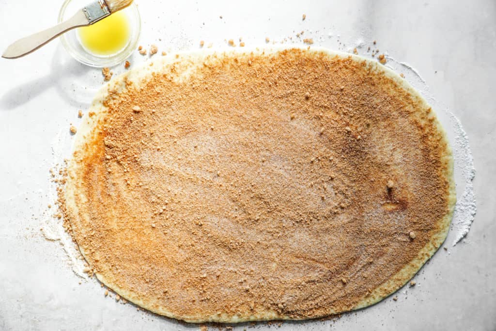 Cinnamon and sugar on dough for easy homemade cinnamon buns.