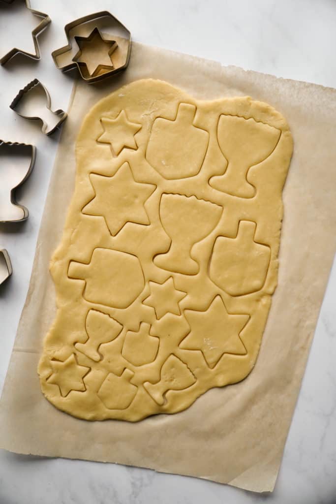 cutting out shapes for Chanukah sugar cookies
